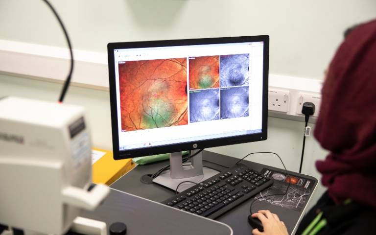 Student looks at scan on eye on computer screen