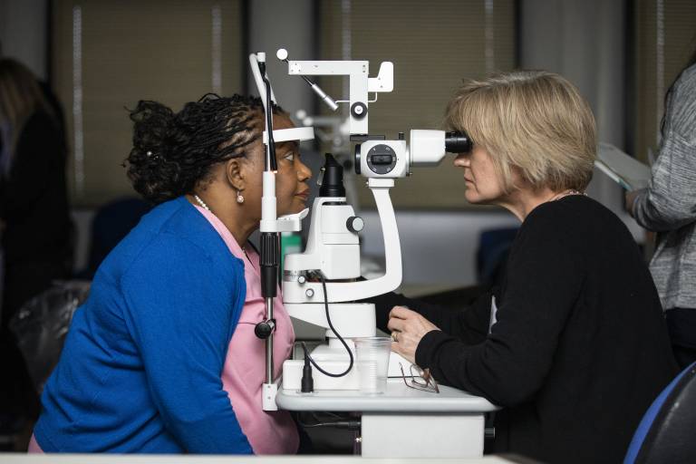 student carrying out eye test on patient 