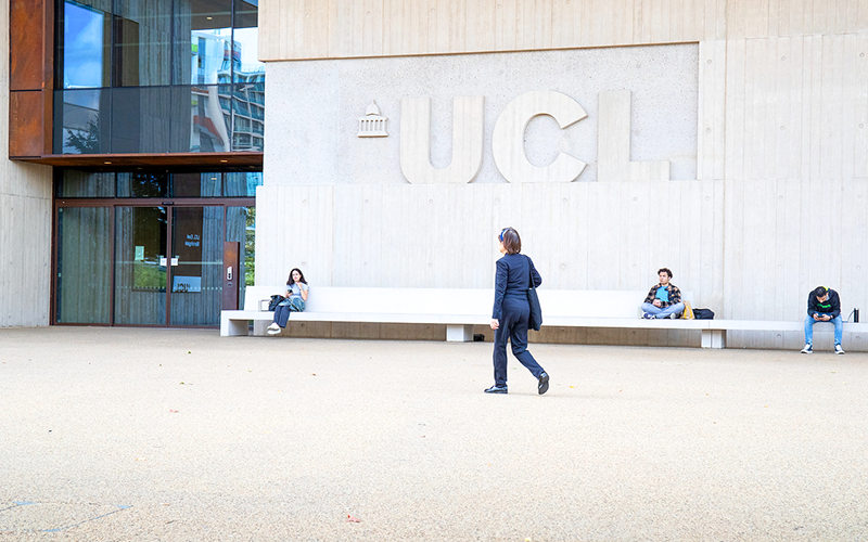 The letters 'UCL on a stone wall