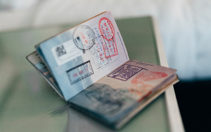 An open passport with different stamps