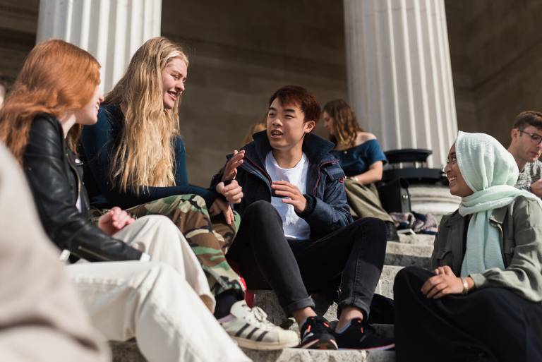 Students chatting on the steps of the UCL portico