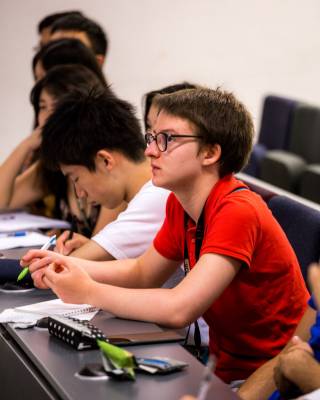 Juliette listening and taking notes in a UCL Pre-University Summer School lecture
