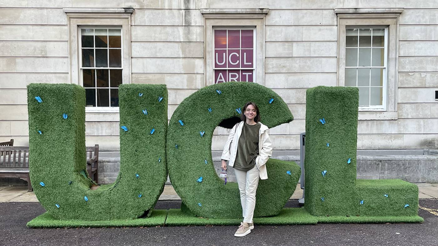 Natalia on campus stood in front of big UCL letters