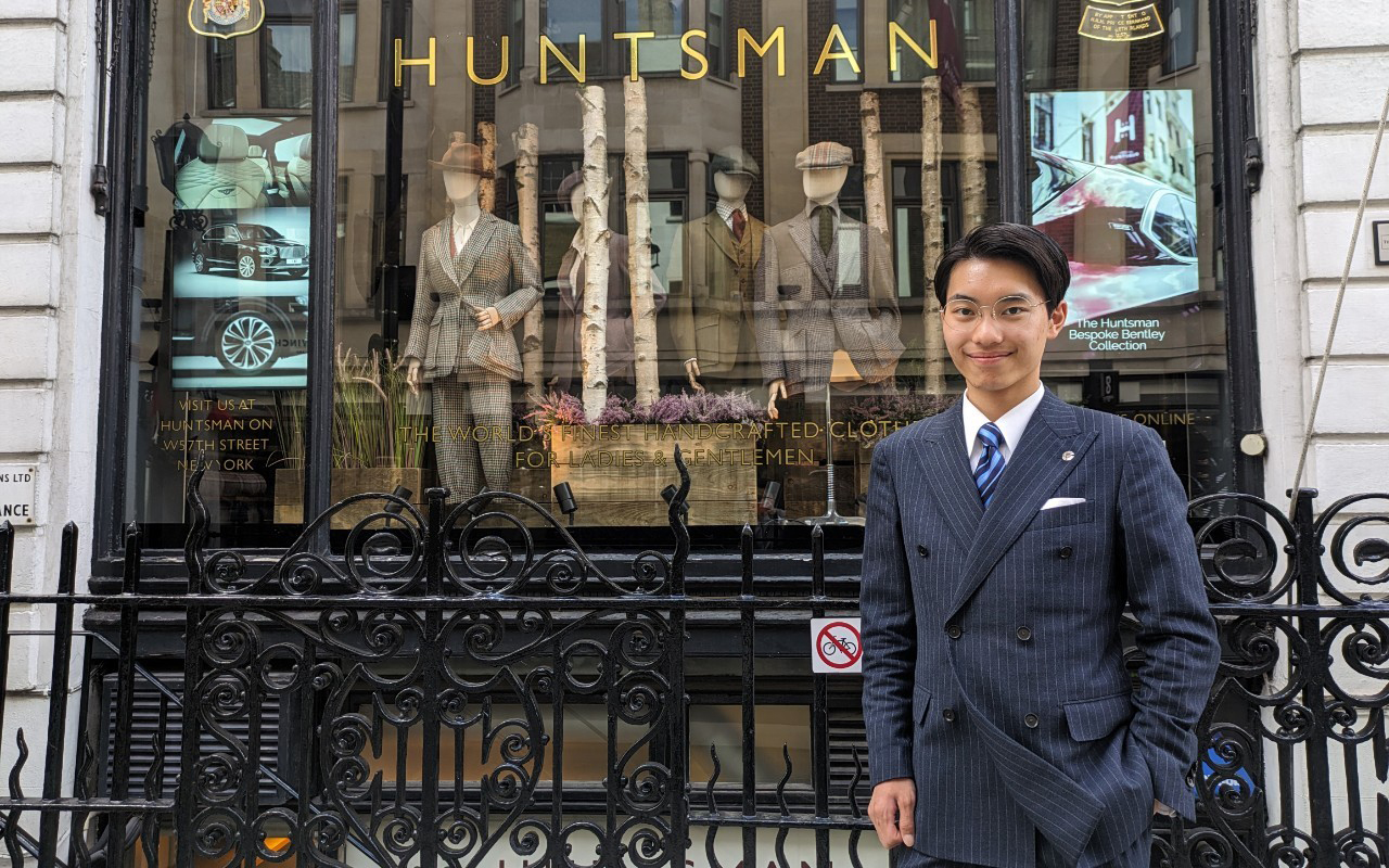 Taiki stood in front of the Huntsman shop