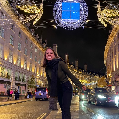 Zeynep UPC UCL foundation course student in front of the Christmas lights on Oxford street in London