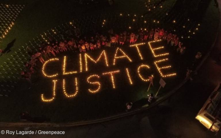 On the eve of Typhoon Haiyan 3rd year anniversary, people from Tacloban light candles that spell out "Climate Justice”, to commemorate the devastating landfall. 