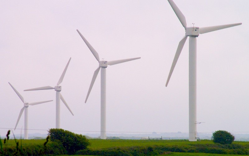 Four turbines against a grey sky background in North Wales