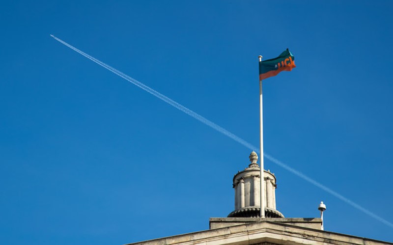 UCL flag from Portico with blue skies