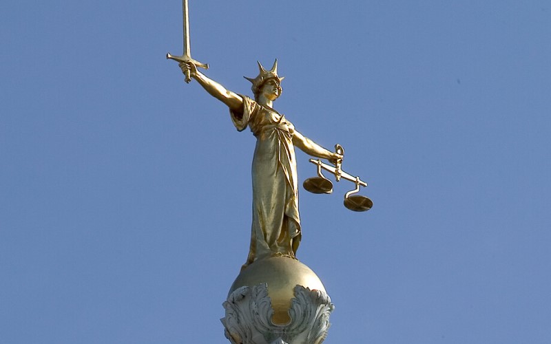 Lady Justice statue on top of the Criminal Court