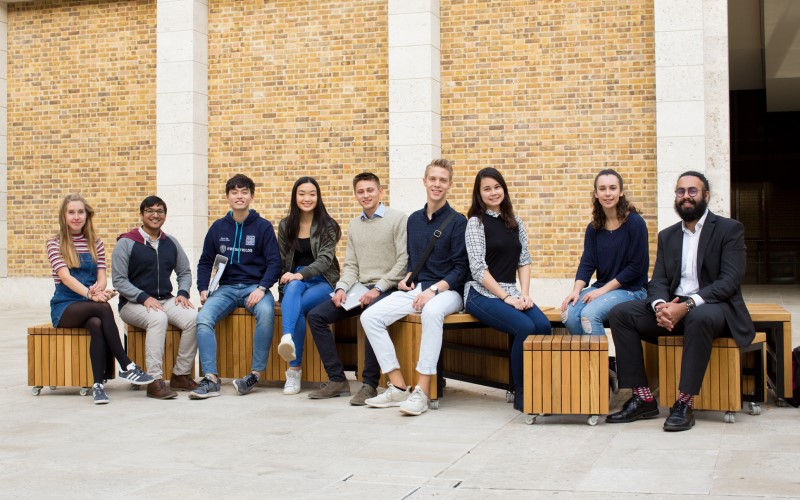 Members of the UCL Law Society in 2017 sitting on benches