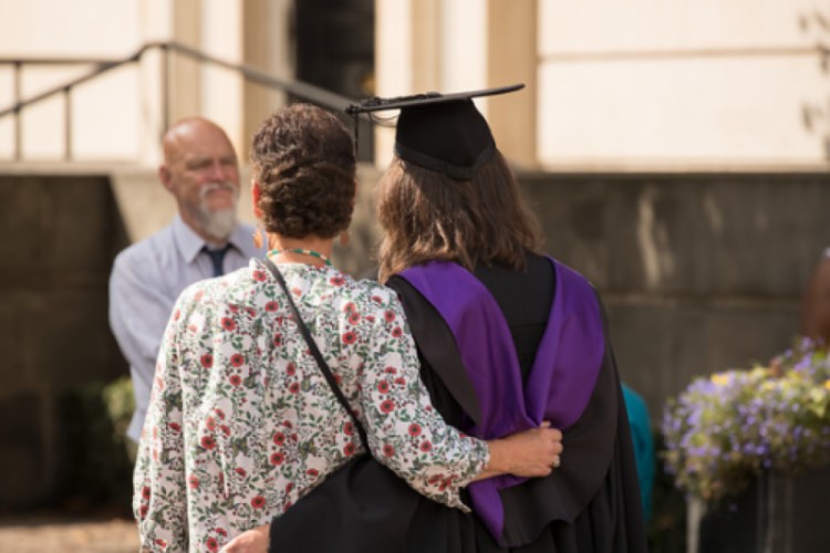 parent and student hugging at graduation 