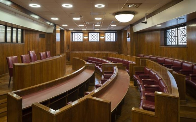 Empty seats in the Moot Court at Bentham House, a mock courtroom style room