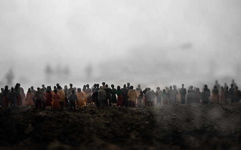 A crowd of people, with fog visible in the background.