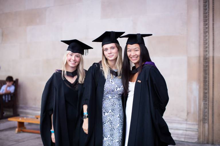 Three UCL Laws graduates smiling