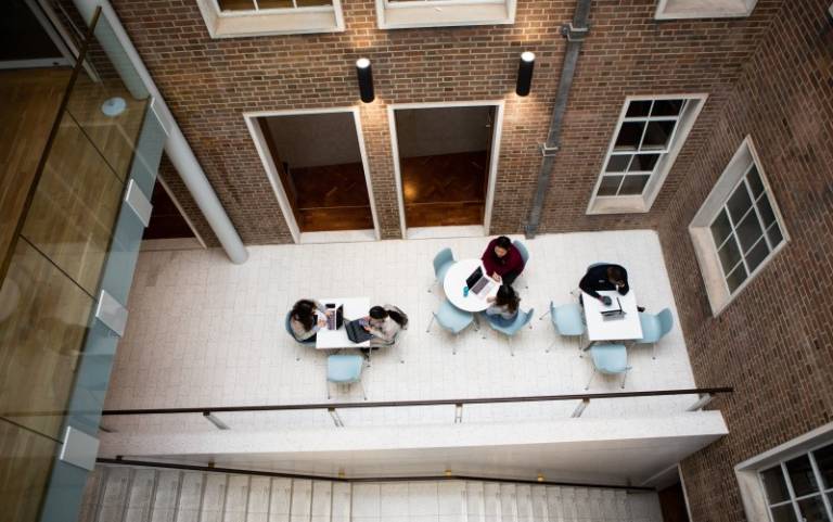 Bentham House hub and stairs, with students sitting and chairs