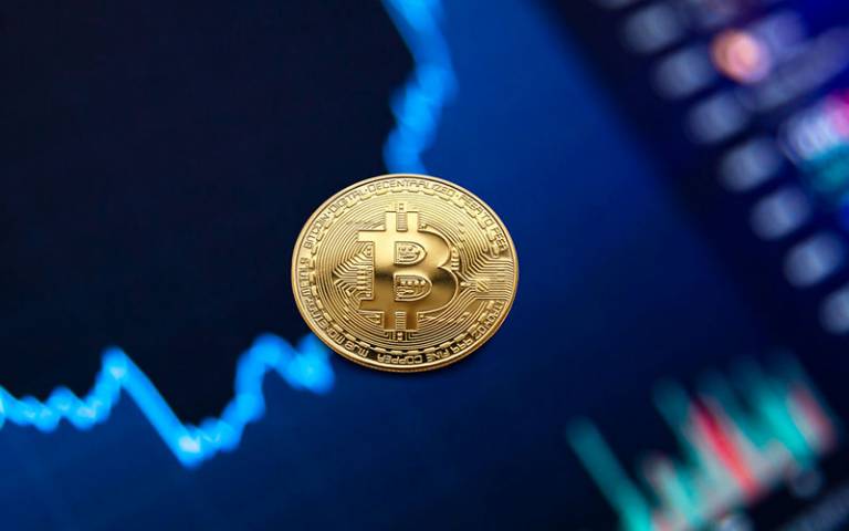 Image of a bitcoin on a blue background