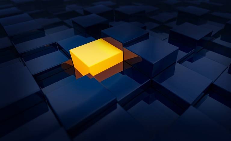 Image of a yellow cube amongst dark blue cubes
