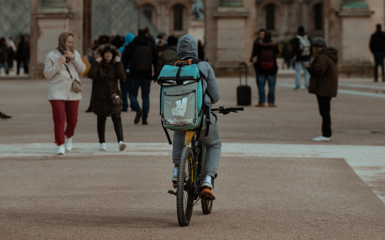 Image of a deliveroo courier on their bike
