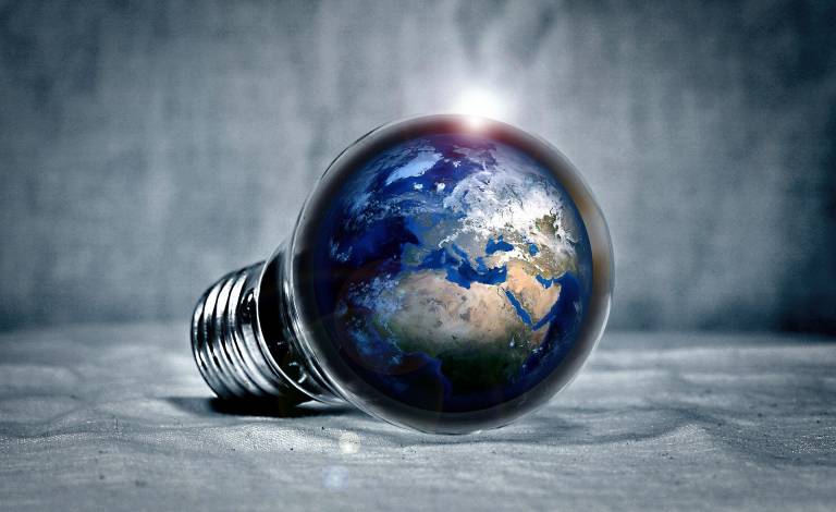 Imagine of a light bulb with the image of earth inside it