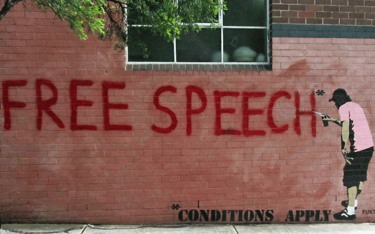 image of words 'free speech' against a concrete wall