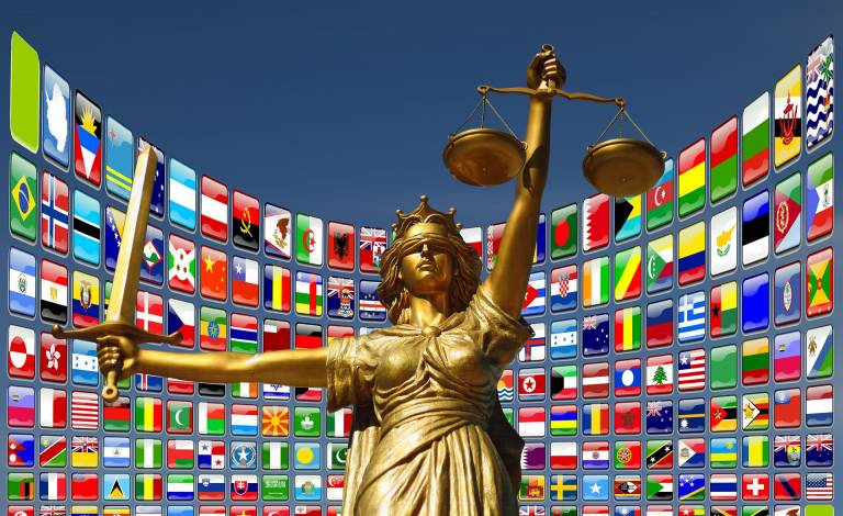 image of the lady of justice with different flags behind her