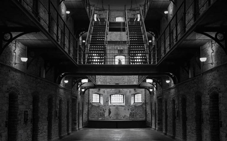 Black and white image of a prison cell