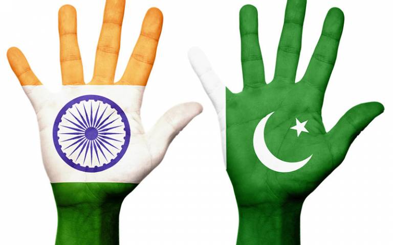 India and Pakistani flags on hands