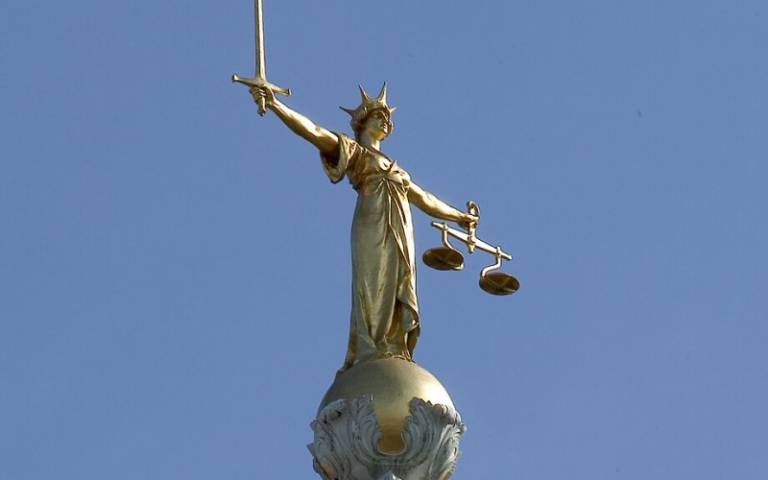 Lady Justice statue on top of the Criminal Court