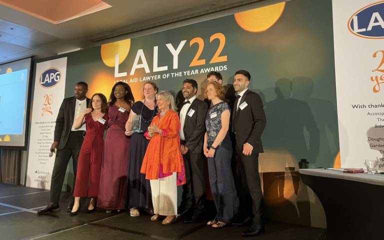 The UCL iLAC team standing on stage holding their award
