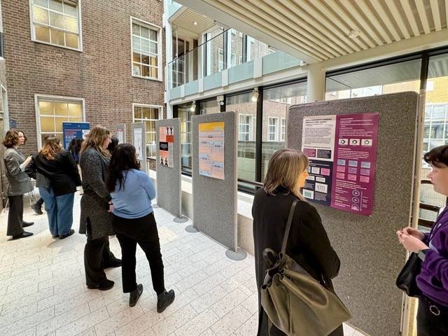 People looking at a poster display