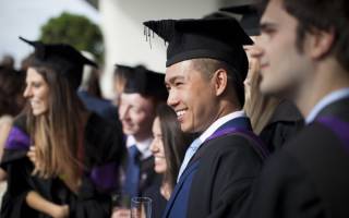 Man smiling at graduation ceremony