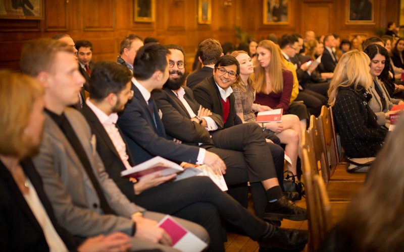 A row of people sitting together and talking at the UCL Laws Prizewinners ceremony 2018
