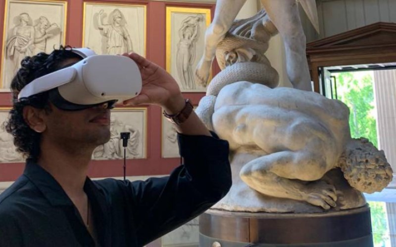 Person using virtual reality headset, stood in the UCL Flaxman Gallery