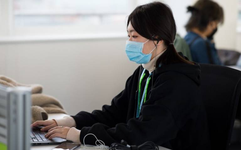Student studying, wearing a face mask