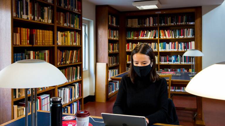 Student studying, wearing a face mask