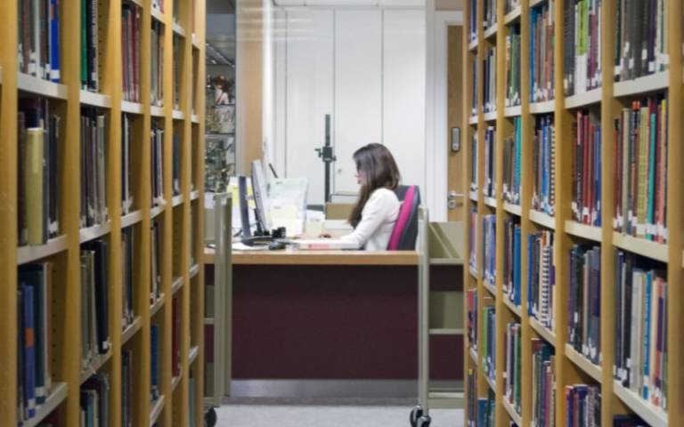 A librarian works amidst the book shelves in the Ophthalmology Library.
