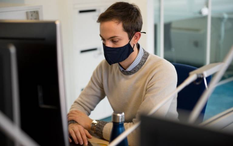 Student at desk, wearing a face mask