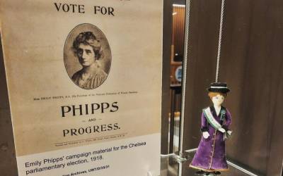 'Vote for Philips' leaflet and a suffragette doll on a shelf