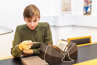 Student examining a rare book from UCL Special Collections
