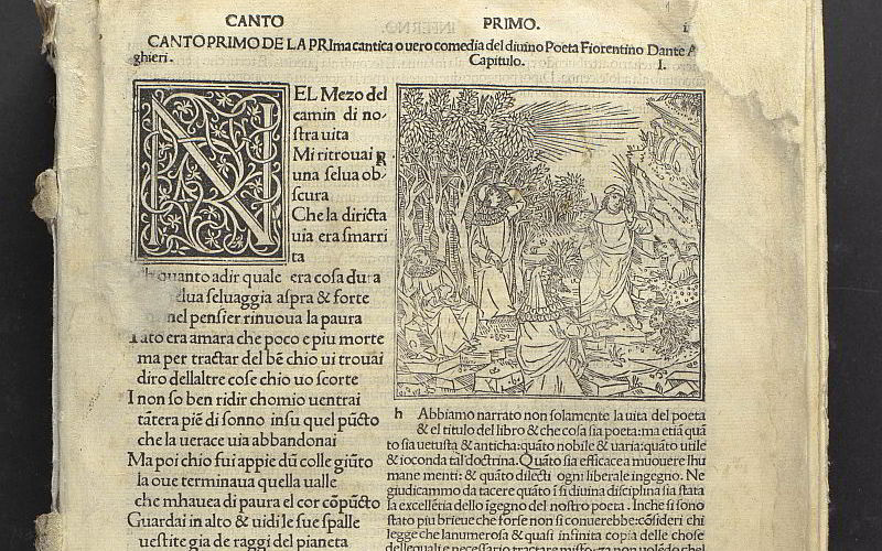 A printed page laid out in two columns. At the top of the right column is an engraving of four men resting in a desert area with some wild cats. On the right is a printed N decorated with a printed vine pattern.