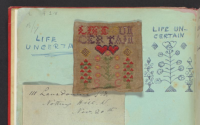 A page of a scrapbook that includes a hand written note in neat cursive lettering. Another note is stuck next to it in a different hand. Above are sketches and an embroidery sample.