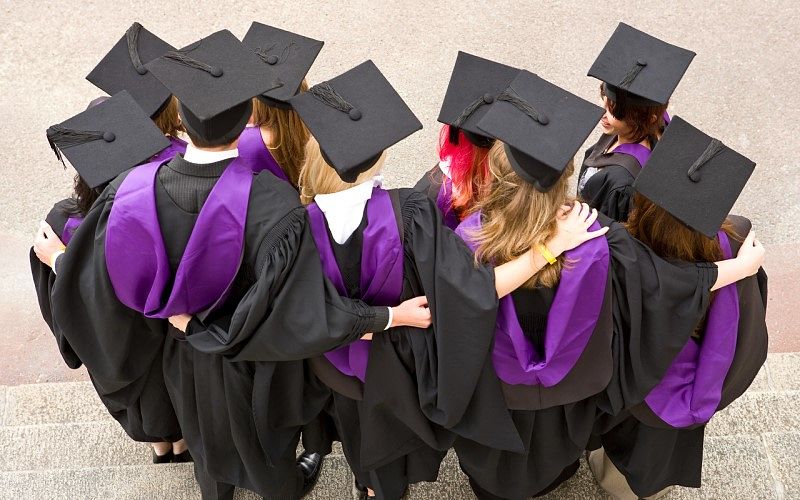 Graduating students wearing gowns and mortarboards
