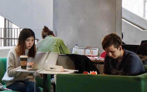 Students working at a desk on campus