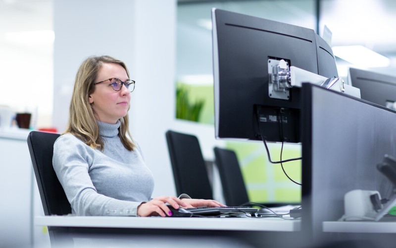 Woman sitting at desk using a computer