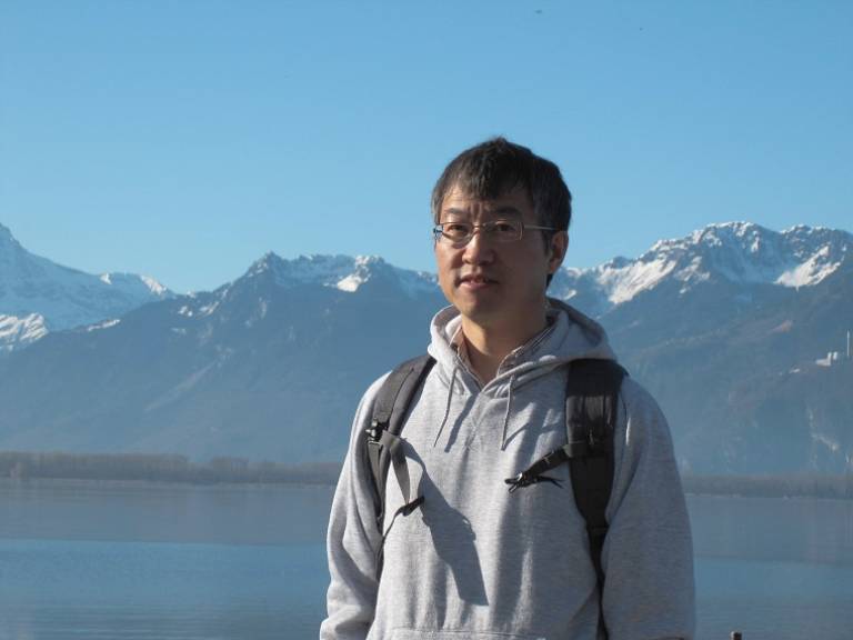 Professor Ziheng Yang standing in an outdoor setting.