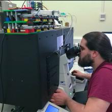 Scientist using super resolution microscope 