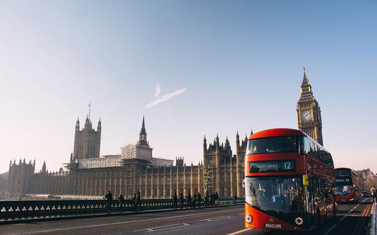 Photo of the Houses of Parliament and a red London bus