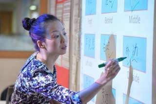teacher writing Mandarin on a whiteboard