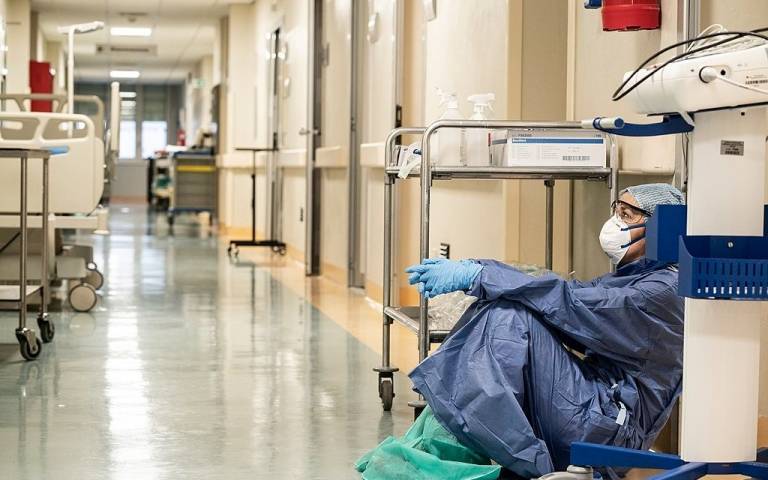 San Salvatore Hospital in Pesaro, Italy, in March. A doctor is pictured at the end of her shift. Credit: Alberto Giuliani. Source: Wikimedia Commons
