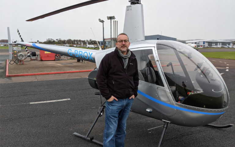 Dr Richard Osborne by the helicopter